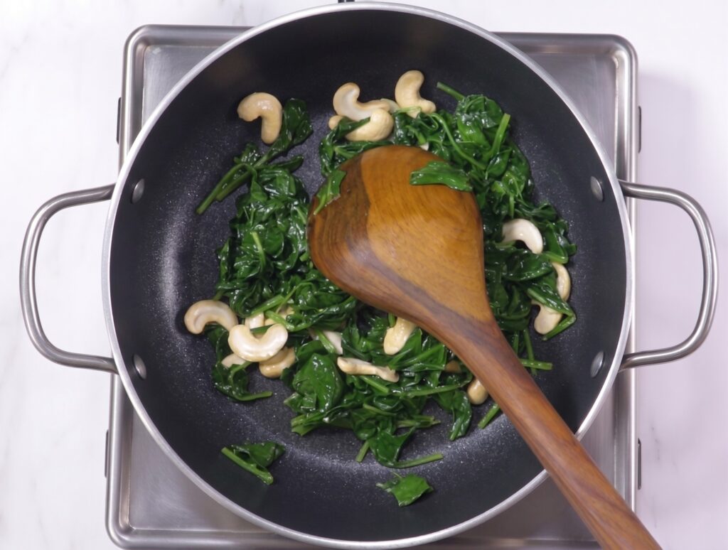 Palak paneer recipe step by step showing spinach puree being added to the pan